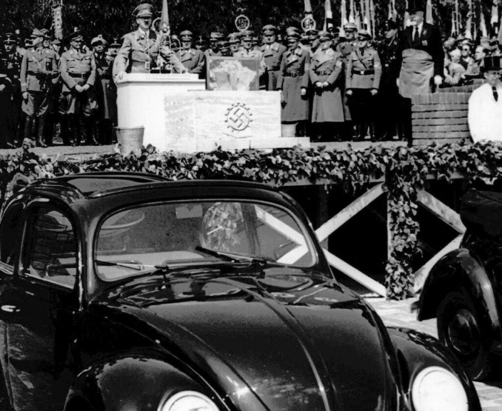 Adolf Hitler in a parade with the Beetle as a propaganda garment. (AP)